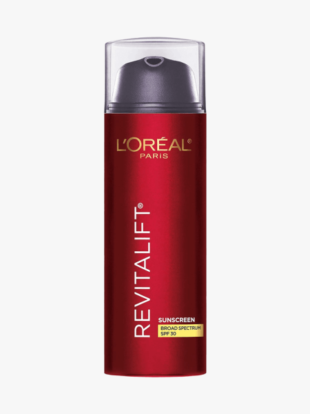 A red pump bottle of L'Oreal Paris Revitalift Triple Power Sunscreen SPF 30 on a light gray background